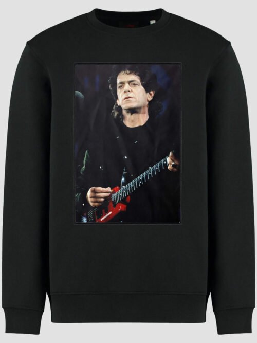 pack shot with patch showing a photograph of Lou Reed performing on stage